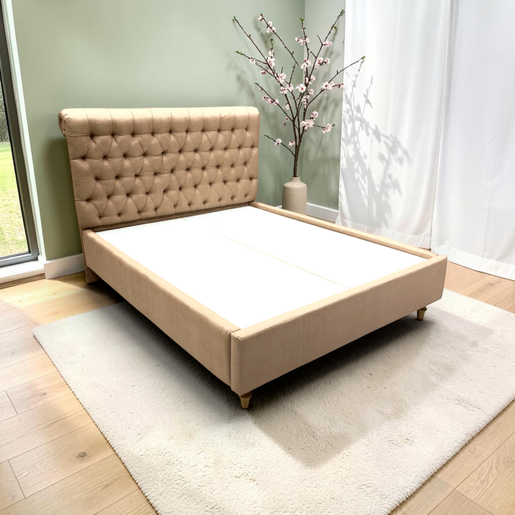 Cleo upholstered queen bed in beige fabric with diamond button-tufted headboard and turned wooden legs, handcrafted in Hyderabad