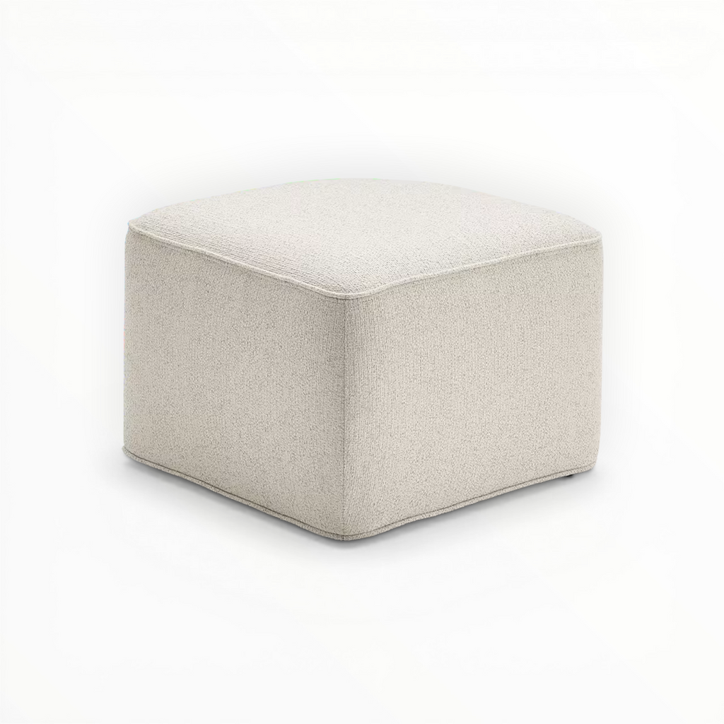 Beige cube-shaped ottoman on a white background