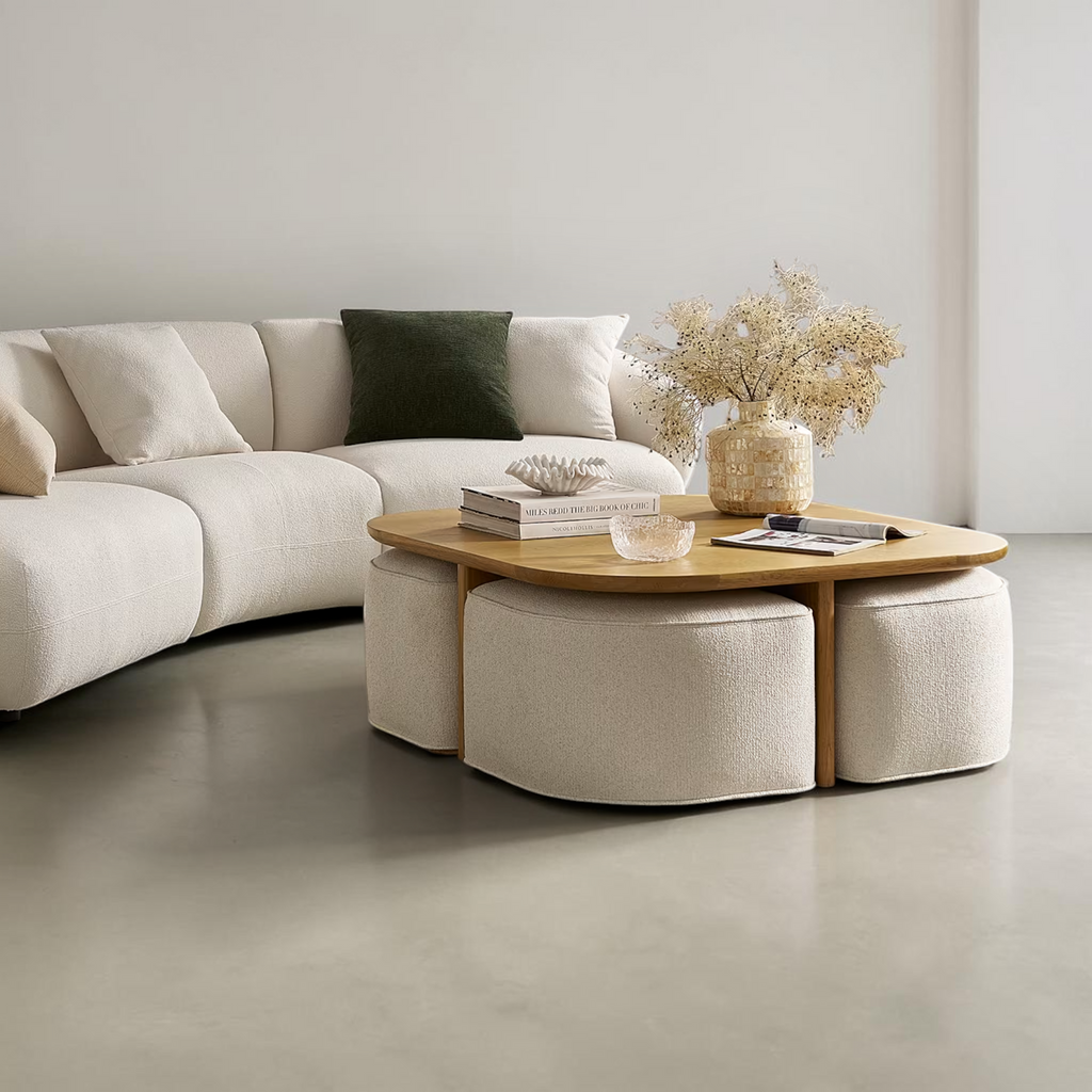Modern living room with a sectional sofa, coffee table, and ottomans.