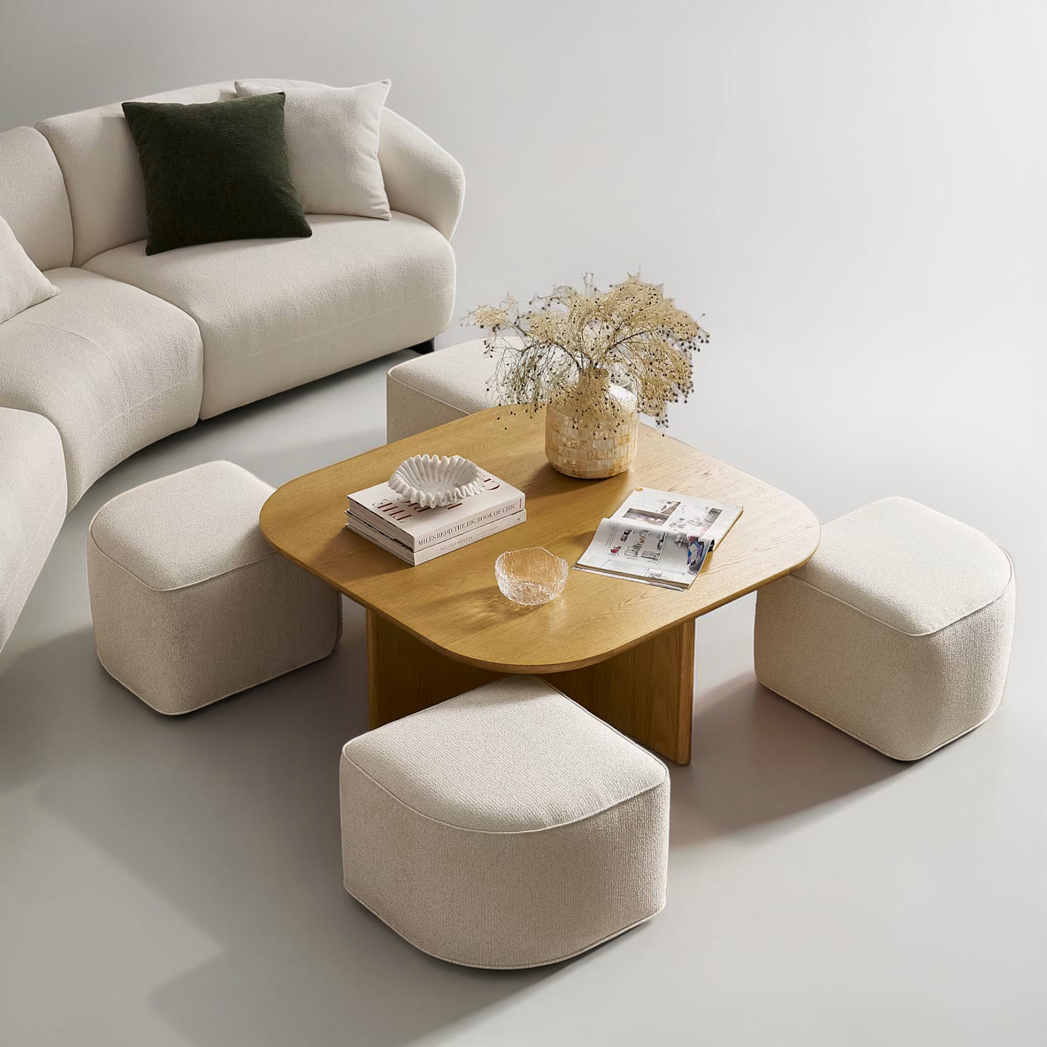 Modern living room with a beige sofa, coffee table, and ottomans.