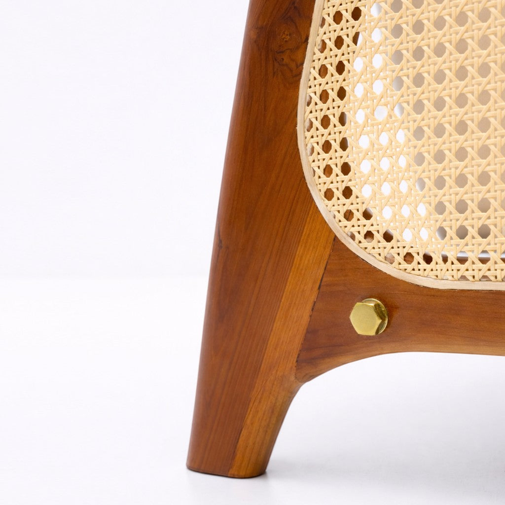 Close-up of a wooden chair with a woven seat on a white background