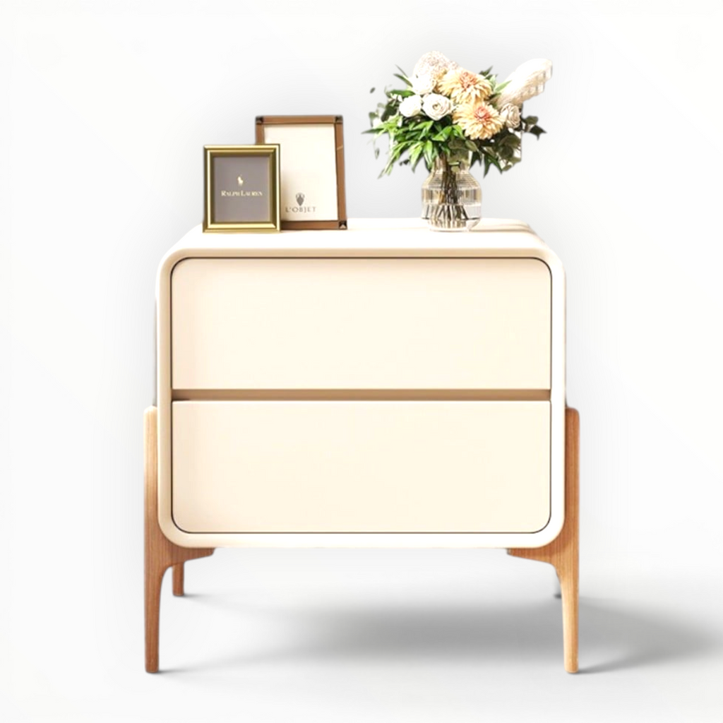 Beige side table with two drawers, a vase of flowers, and two framed pictures on a white background