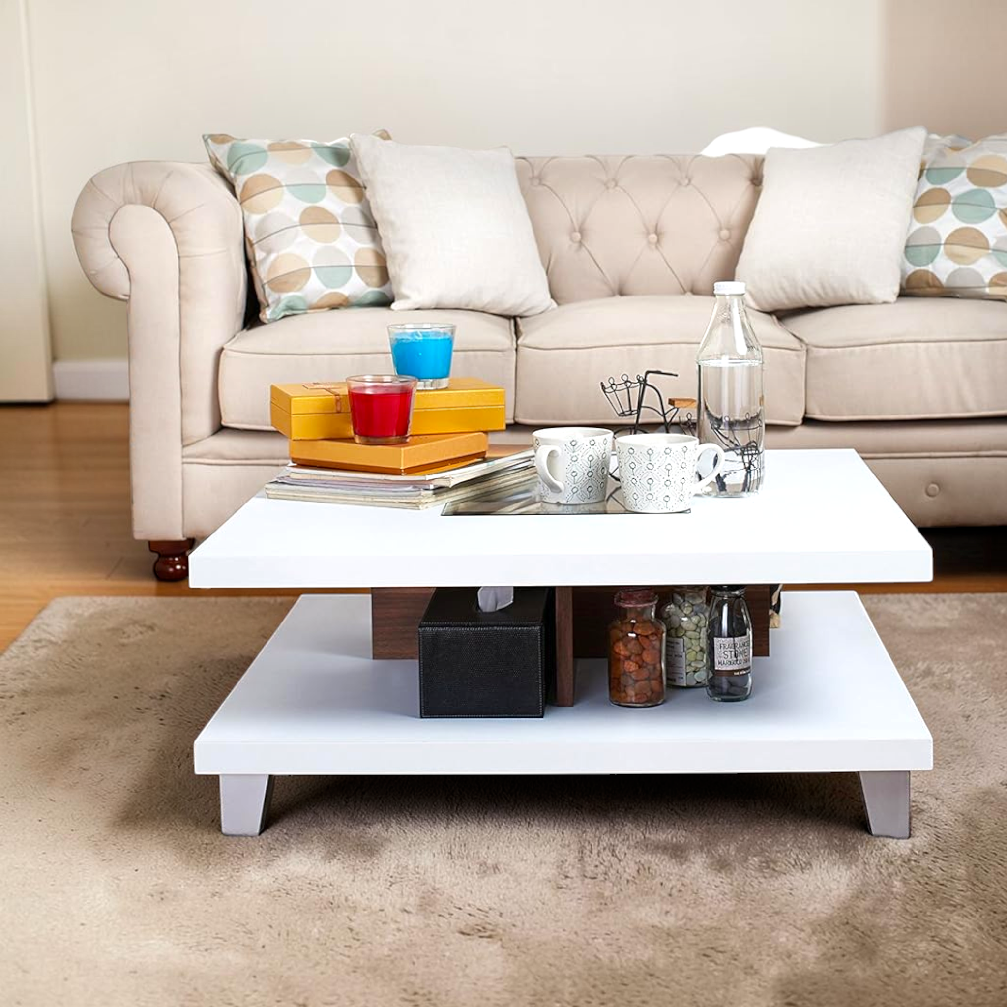Beige sofa with decorative pillows and a white coffee table in a living room setting.