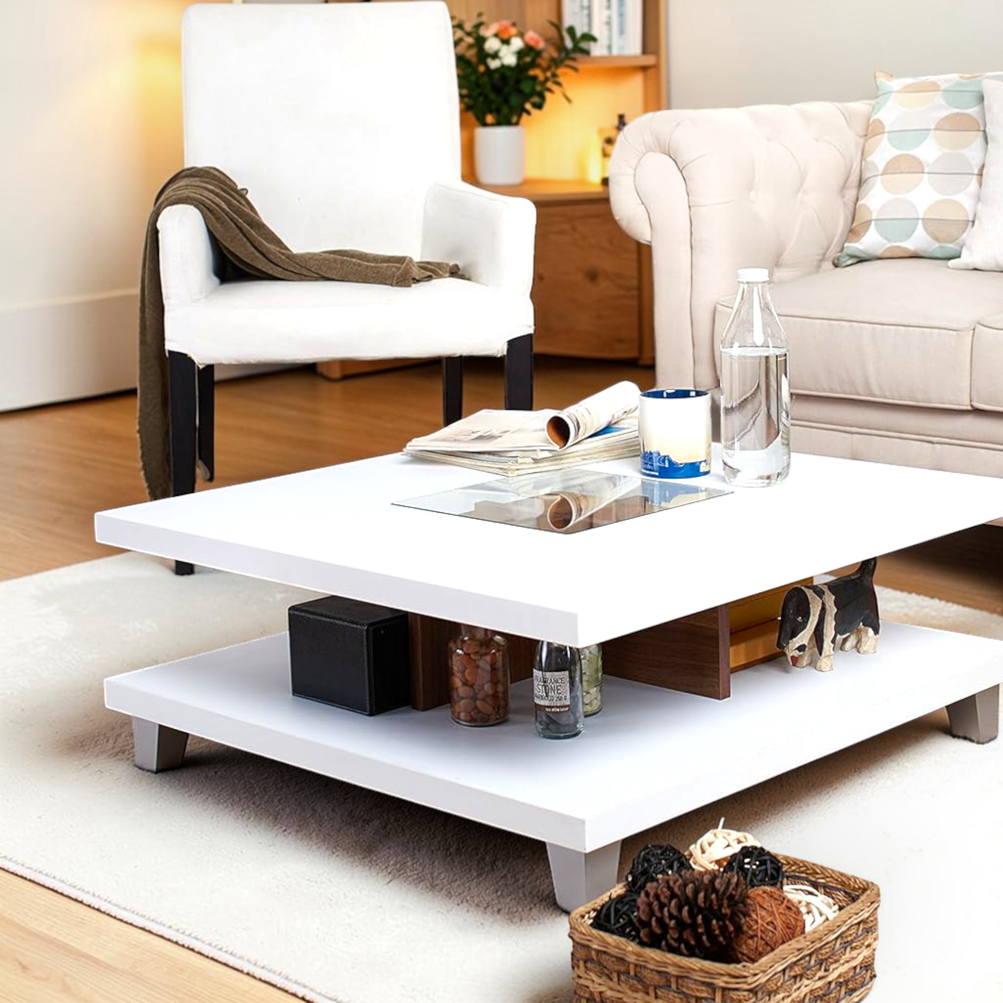 White coffee table in a living room with various items on it, including a bottle and a basket.