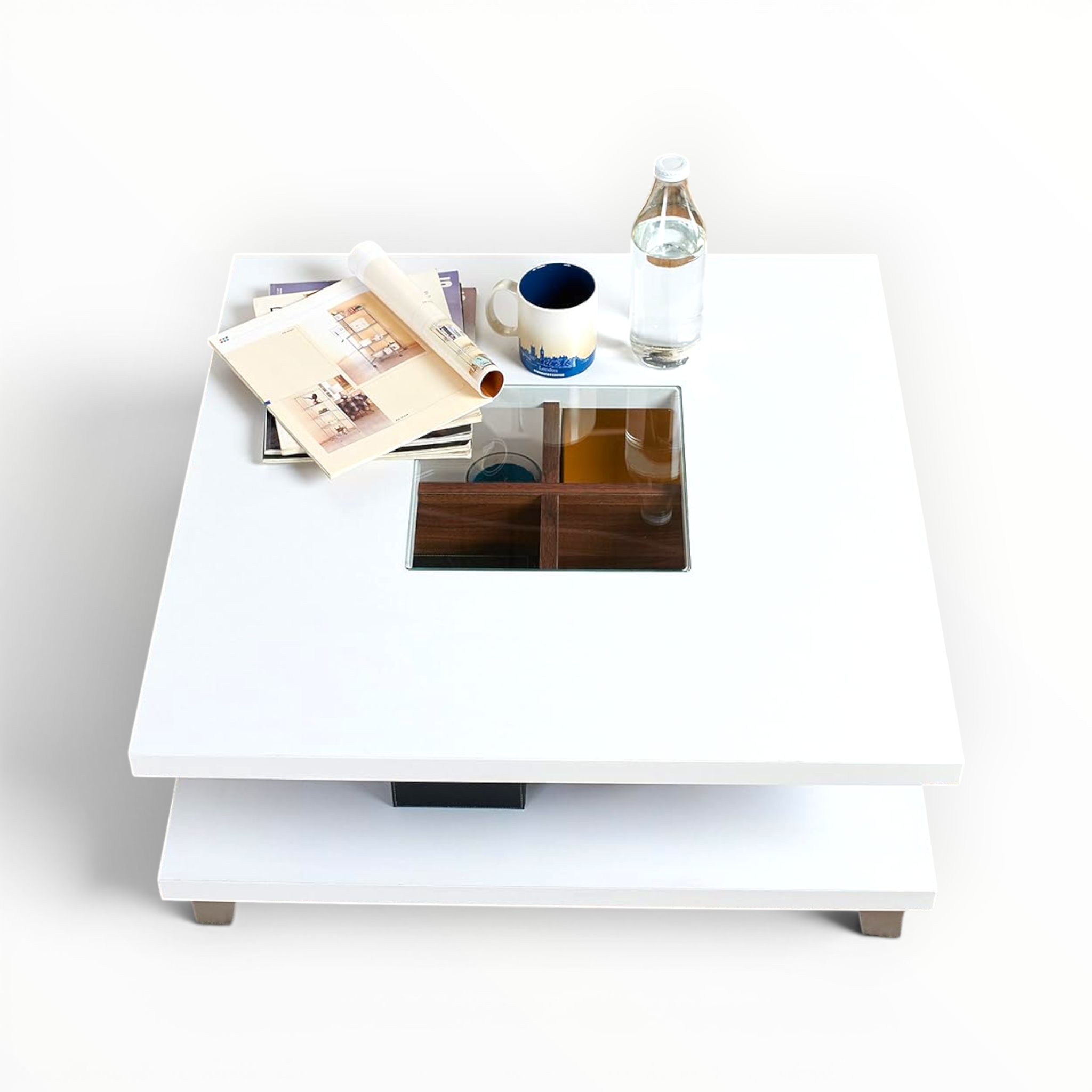 White coffee table with a glass top displaying books, a mug, and a bottle on a white background