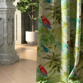 Digitally printed tropical curtain with red macaws, palm fronds and monstera leaves in green and teal, hanging beside a potted tree on a tiled floor