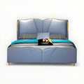 Blue upholstered bed with gold accents on a white background