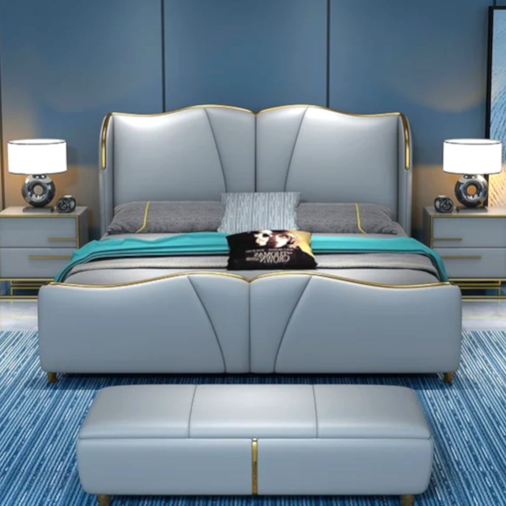 Gray upholstered bed with matching ottoman in a bedroom setting.