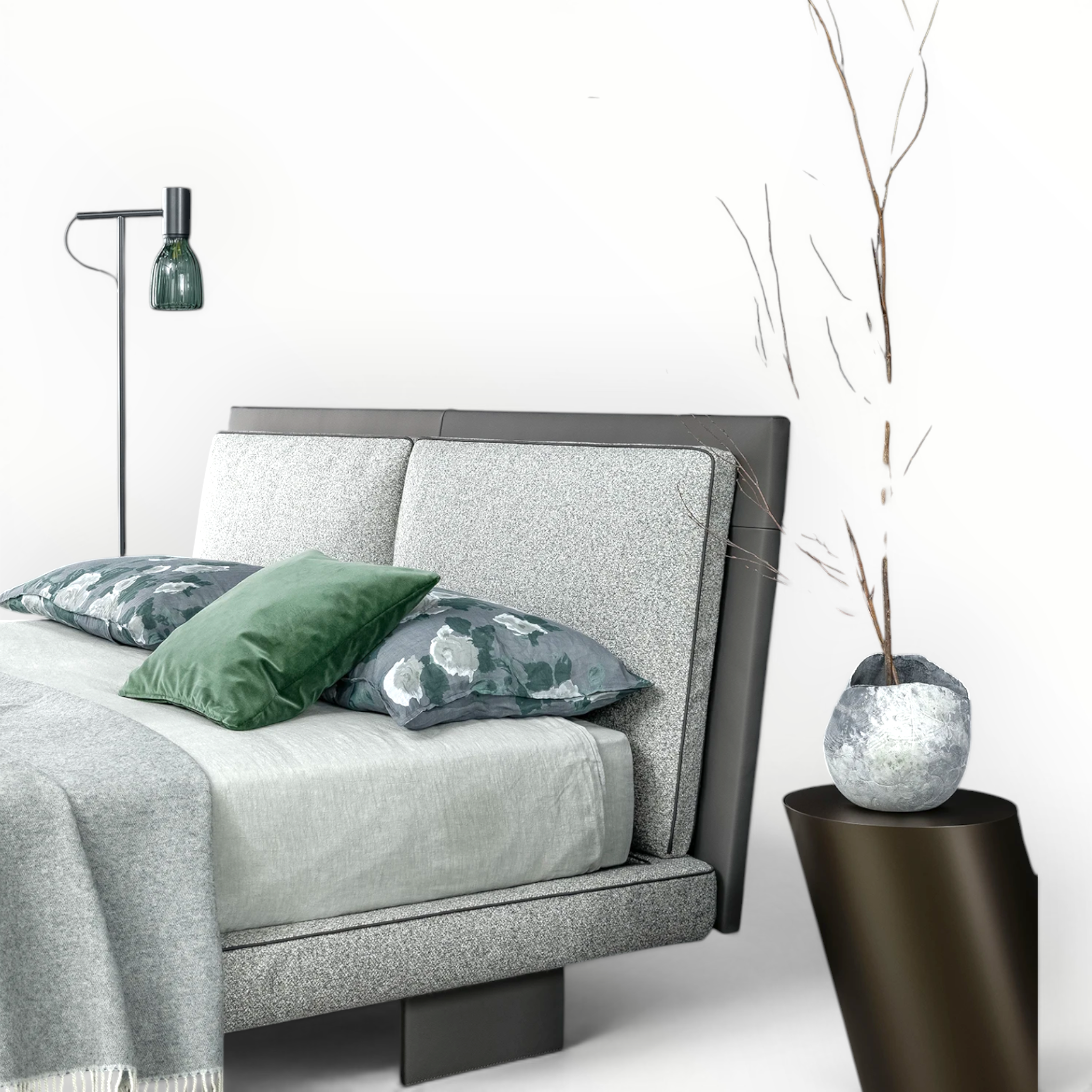 Gray upholstered bed with decorative pillows and a small plant on a white background