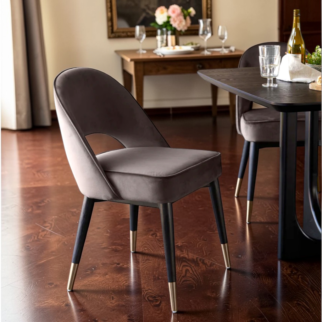 Gray chair with gold feet in a dining room setting