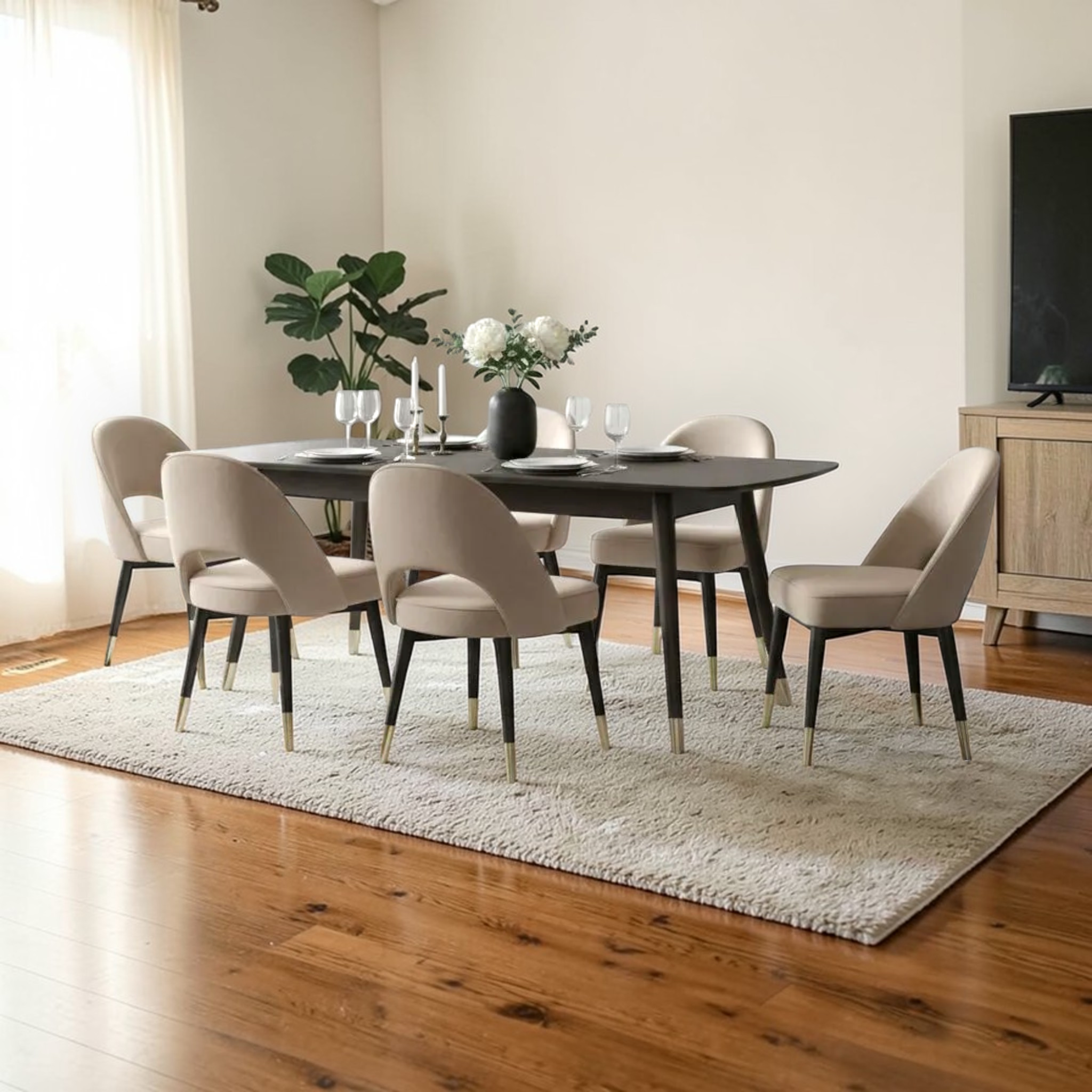Dining room with a round table and chairs on a wooden floor.