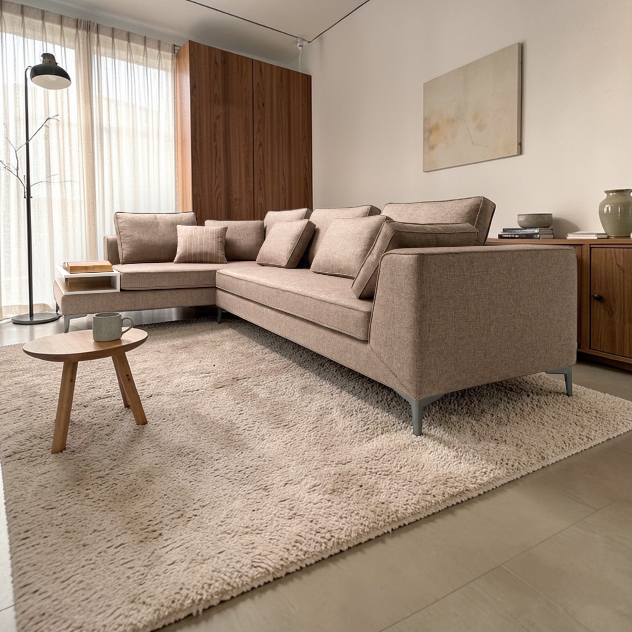 Modern living room with a beige sectional sofa, wooden side table, and abstract painting.