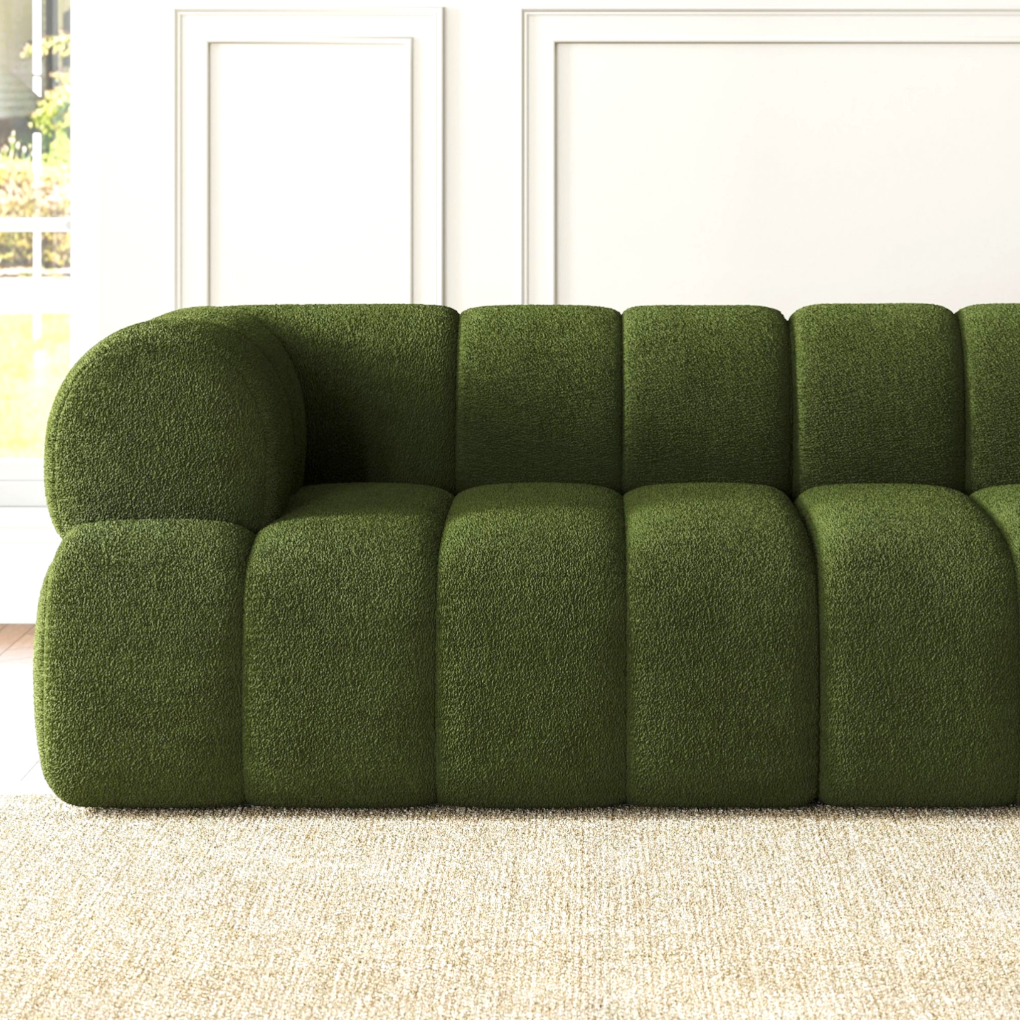 Green sofa in a room with white walls and a window.