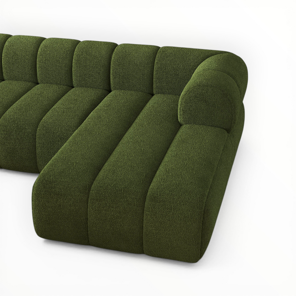 Green sectional sofa on a white background