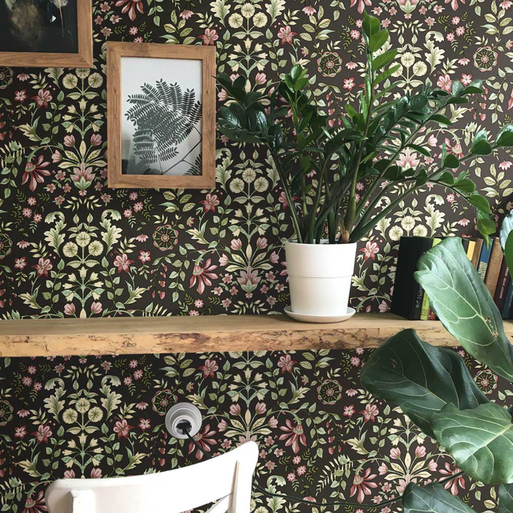 Room interior with floral wallpaper, plants, and a wooden shelf.