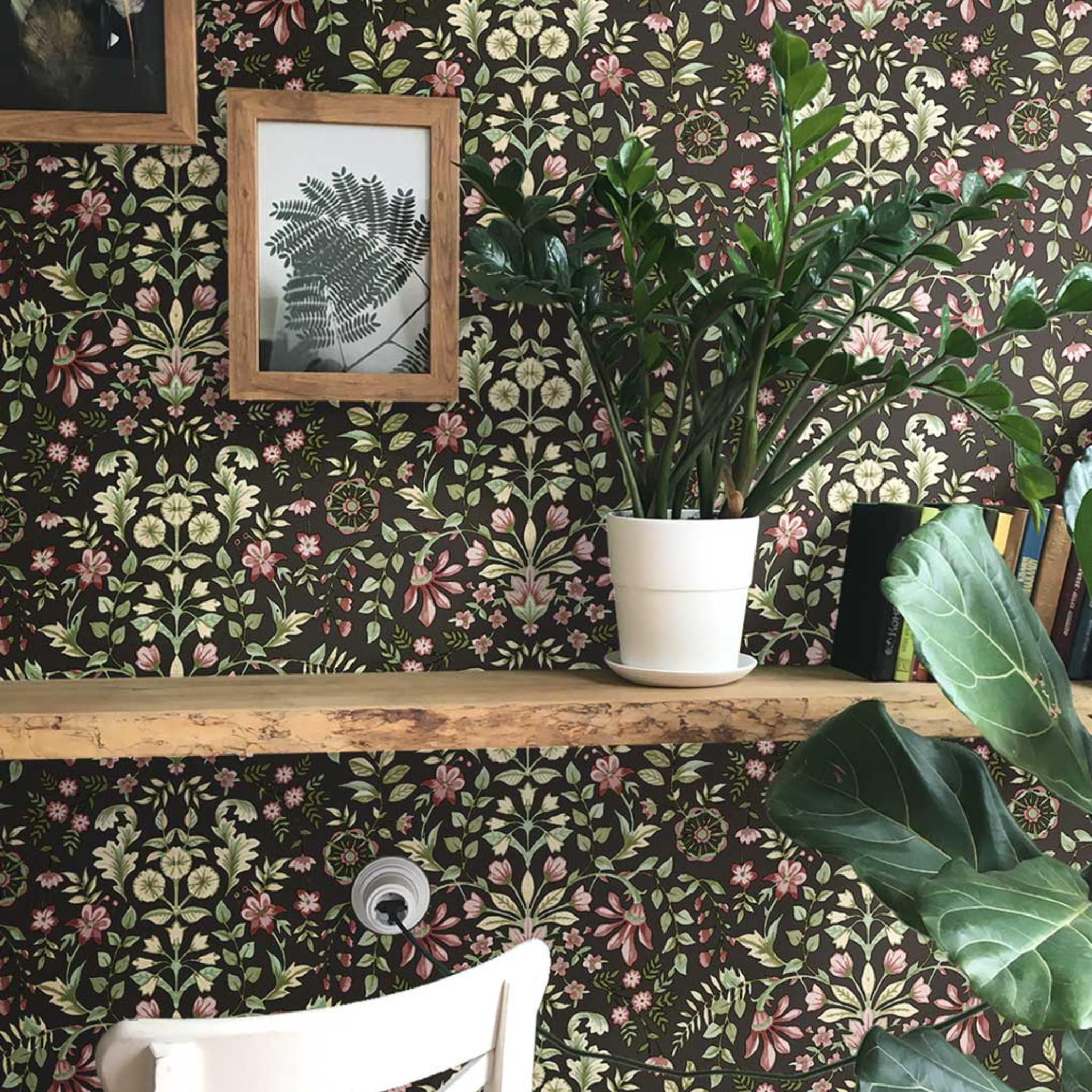 Room interior with floral wallpaper, plants, and a wooden shelf.