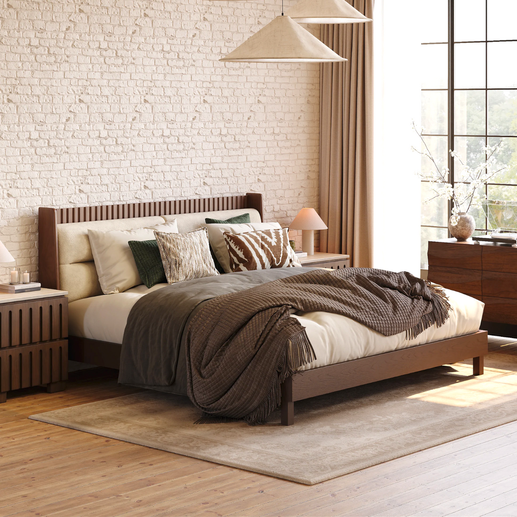 Modern bedroom with wooden bed, brick wall, and large window.