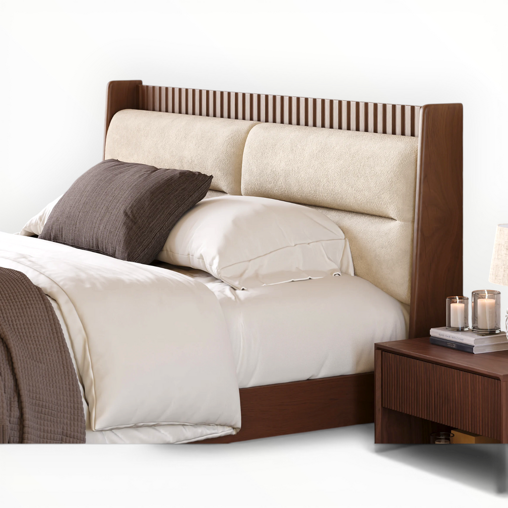 Bed with wooden headboard and nightstand against a white wall