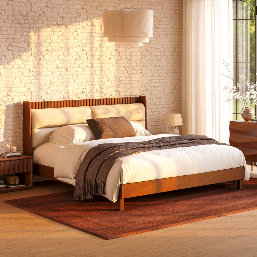 Wooden bed with white bedding in a bedroom setting with brick wall and window.