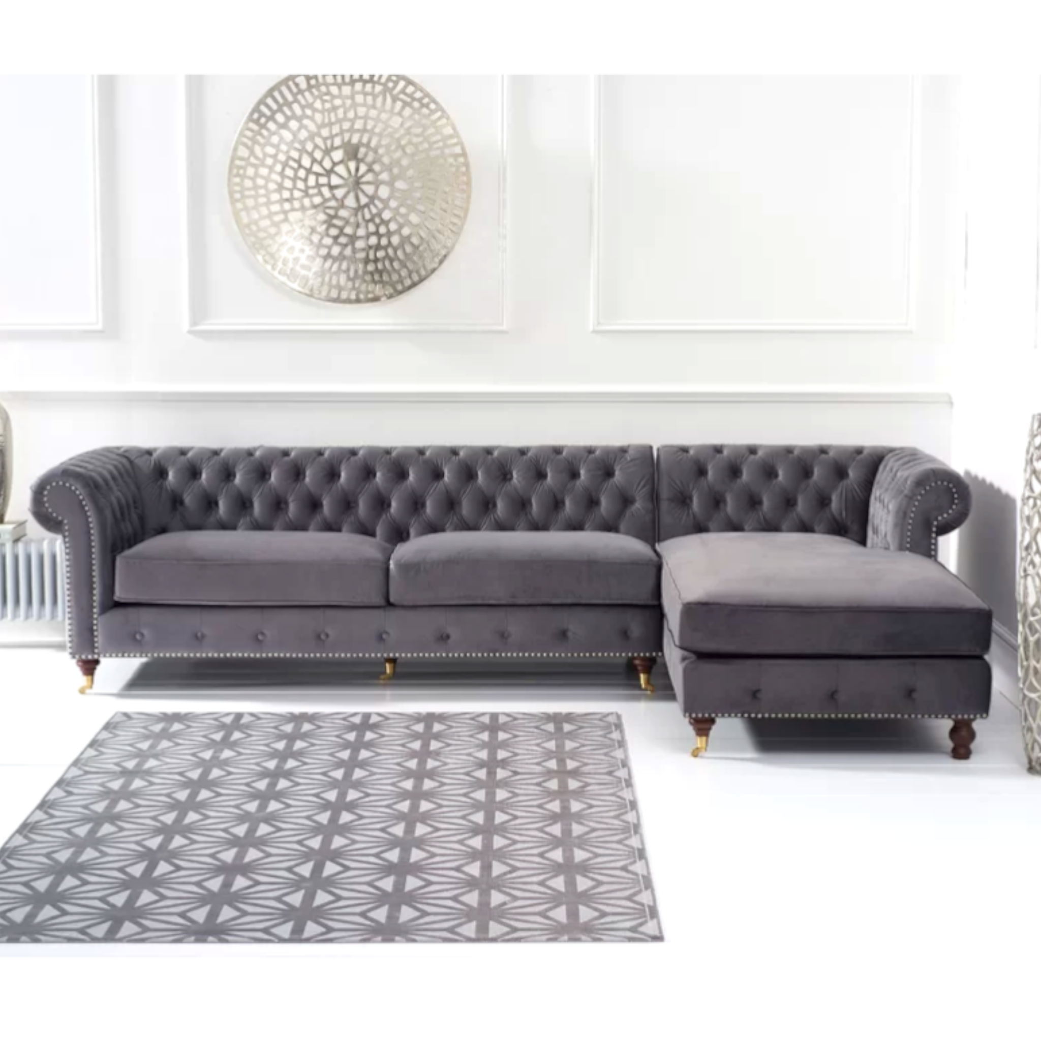 Gray tufted sofa with a matching rug in a living room setting.