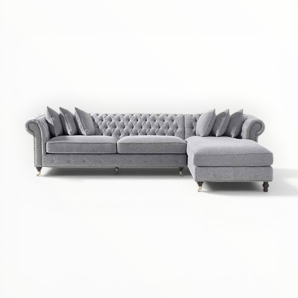 Gray sectional sofa with tufted backrest on a white background