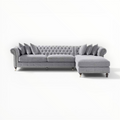 Gray sectional sofa with tufted backrest on a white background