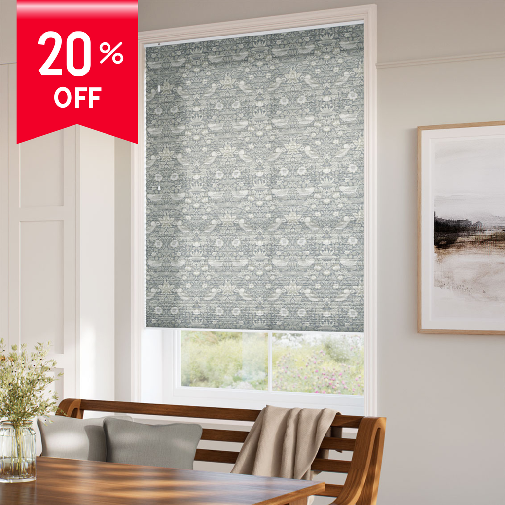 Window with floral patterned roller blind, wooden bench, and 20% off banner.