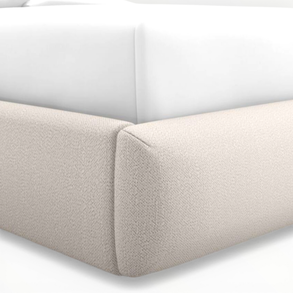 Close-up of a beige upholstered corner of a sofa on a white background