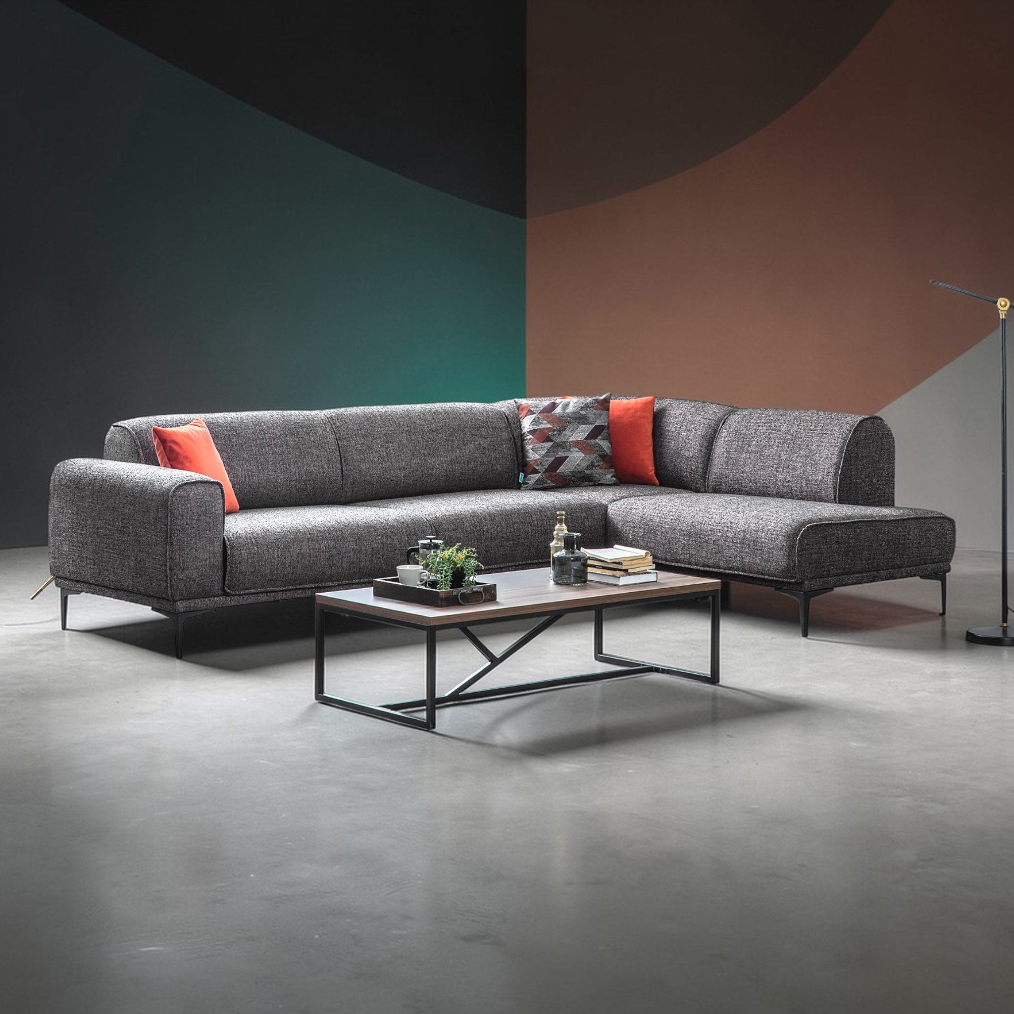 Gray sectional sofa with colorful cushions in a modern room setting.