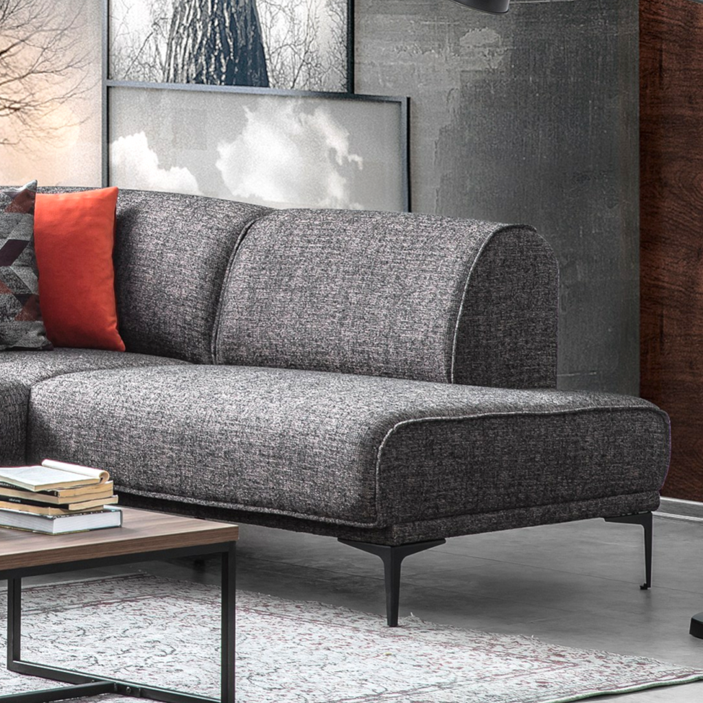 Gray sofa with a red pillow in a living room setting