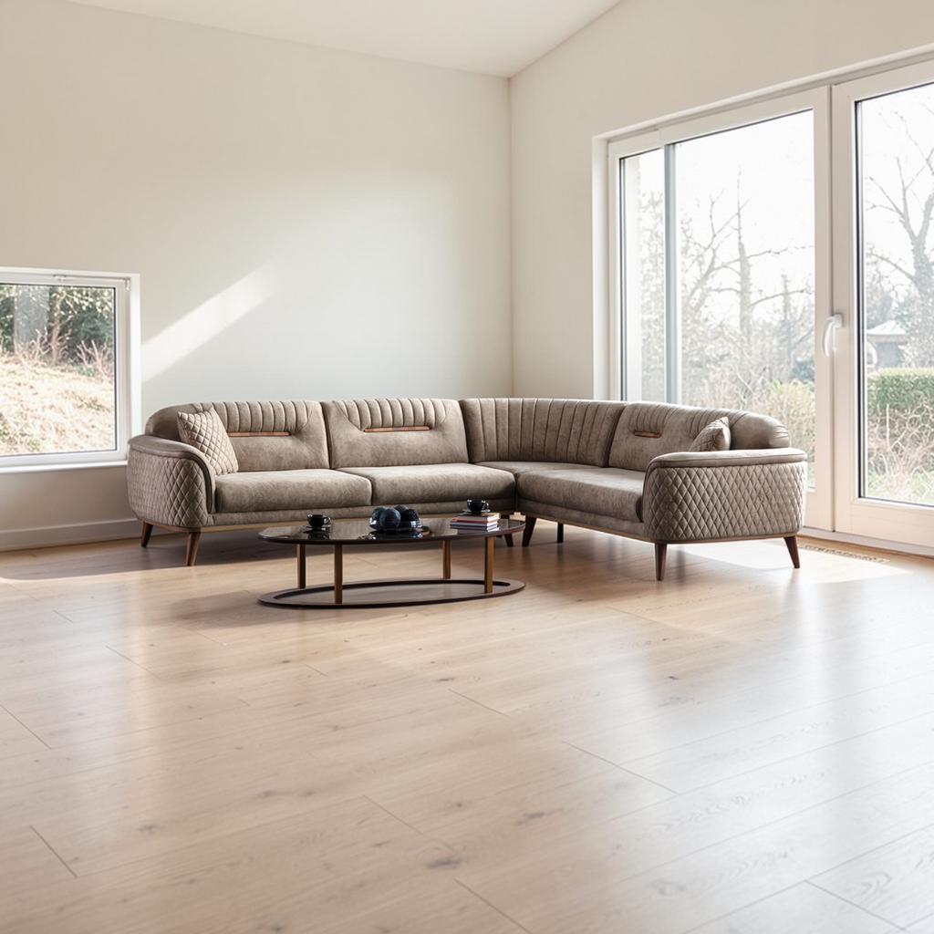 Modern living room with a sectional sofa and coffee table near large windows.