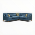 Blue sectional sofa with decorative pillows on a white background