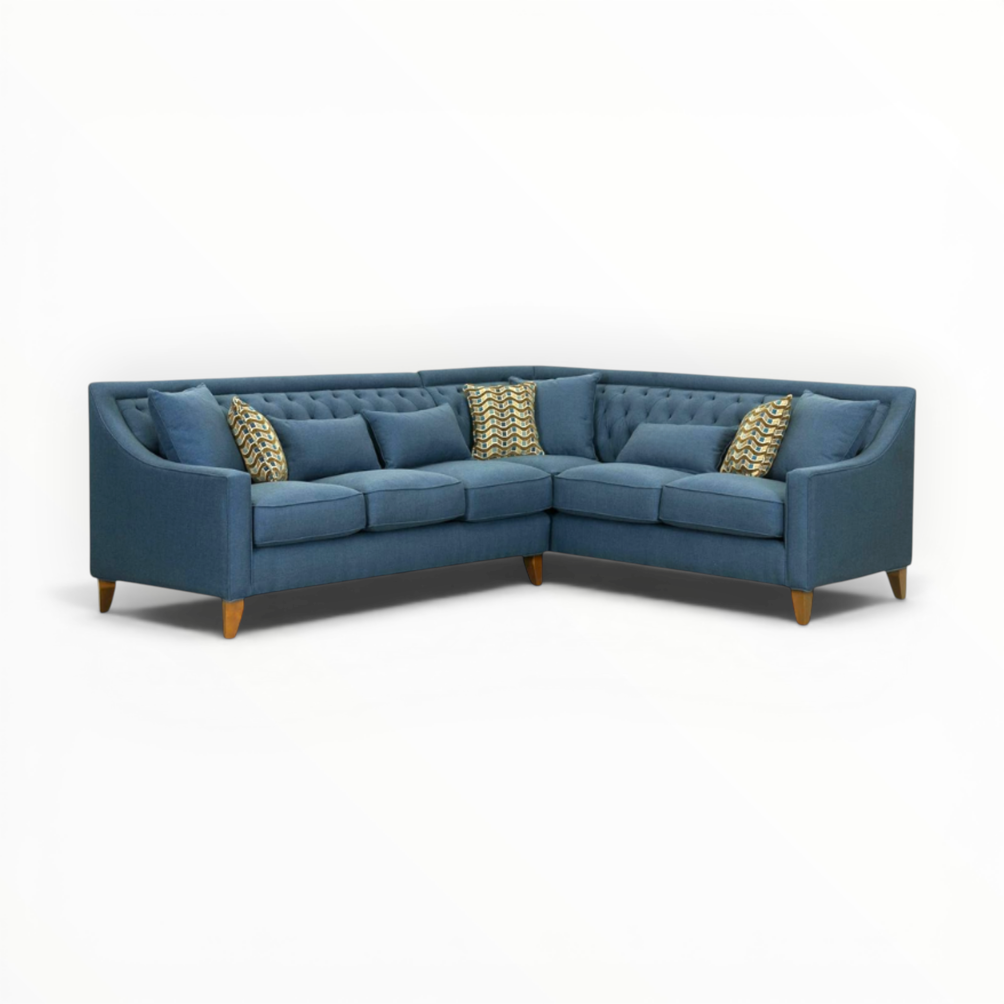 Blue sectional sofa with decorative pillows on a white background