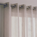 Close-up of a beige open-weave linen-look curtain with a fine grid texture, hung from a metal rod with eyelet rings and letting daylight through
