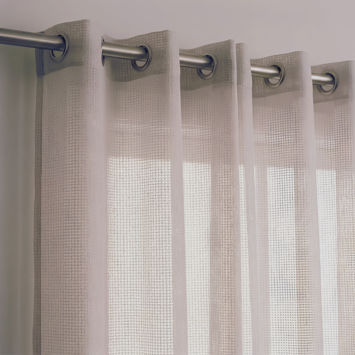 Close-up of a beige open-weave linen-look curtain with a fine grid texture, hung from a metal rod with eyelet rings and letting daylight through