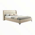 Beige upholstered bed with gray bedding on a white background