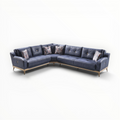 Blue sectional sofa with patterned cushions on a white background