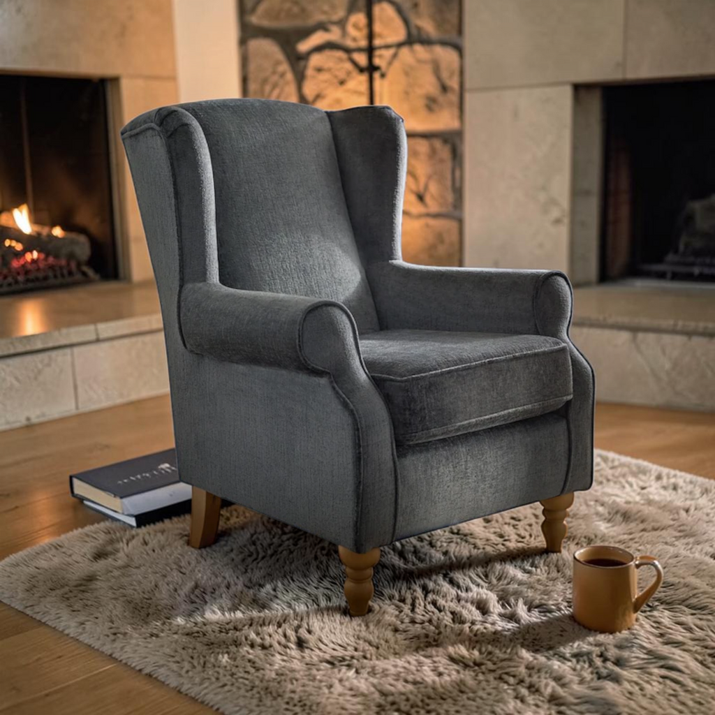 Gray armchair in a cozy living room with a fireplace and a book.