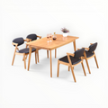 Dining table set with four chairs on a white background