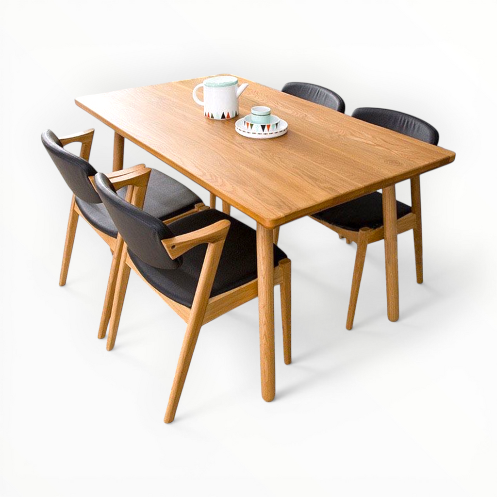 Wooden dining table with four chairs on a white background