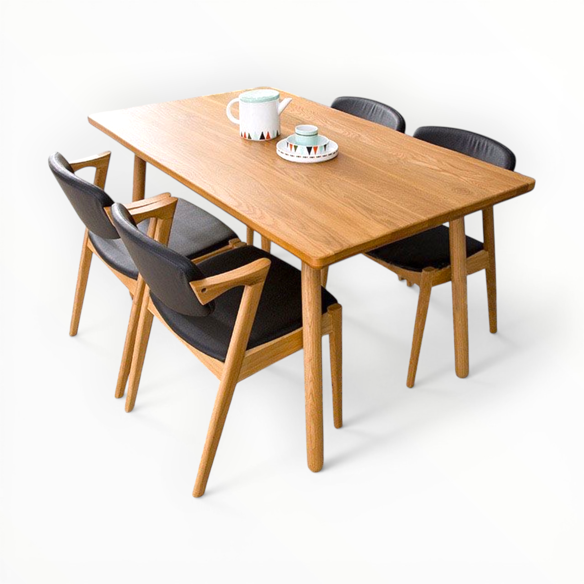 Wooden dining table with four chairs on a white background
