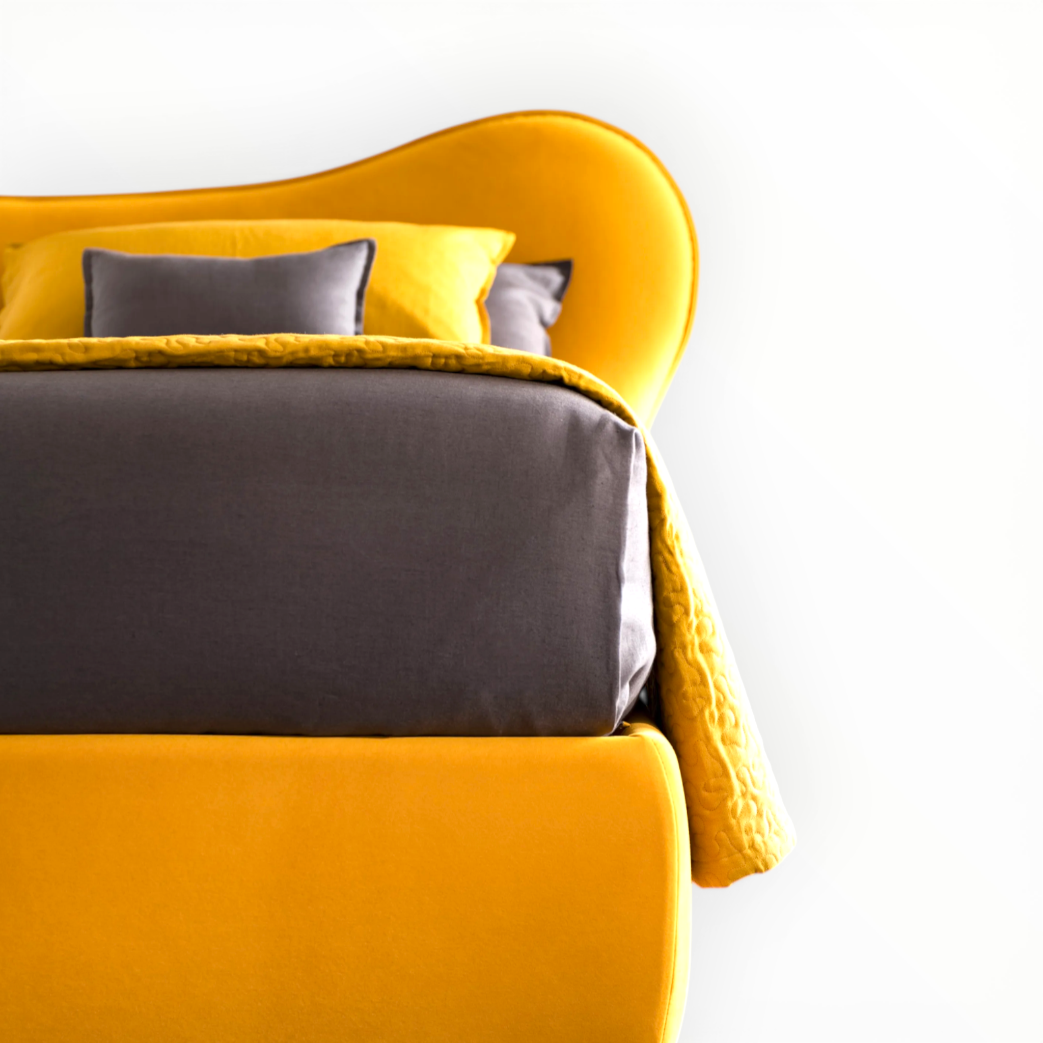 Yellow bed with gray bedding against a white background