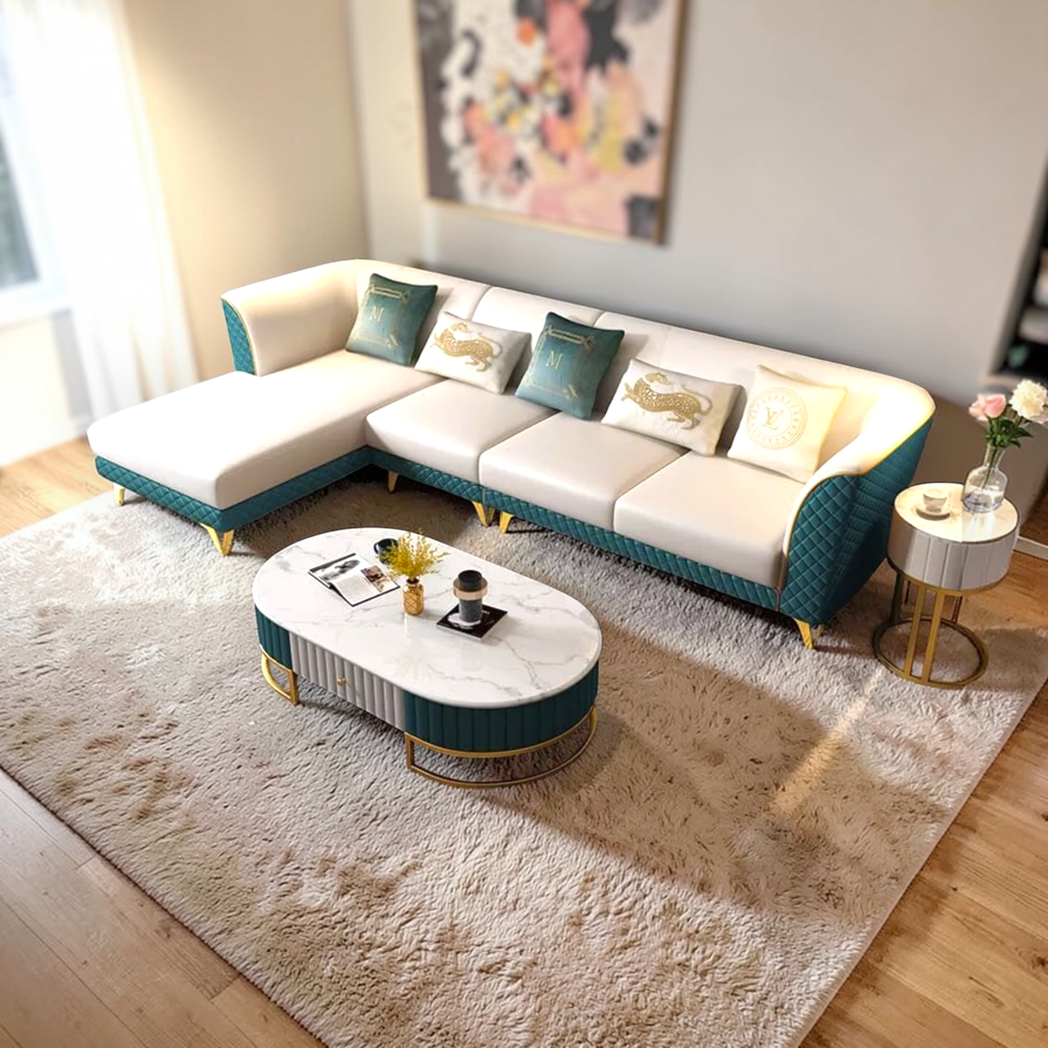 Modern living room with a white and teal sectional sofa, marble coffee table, and decorative pillows.