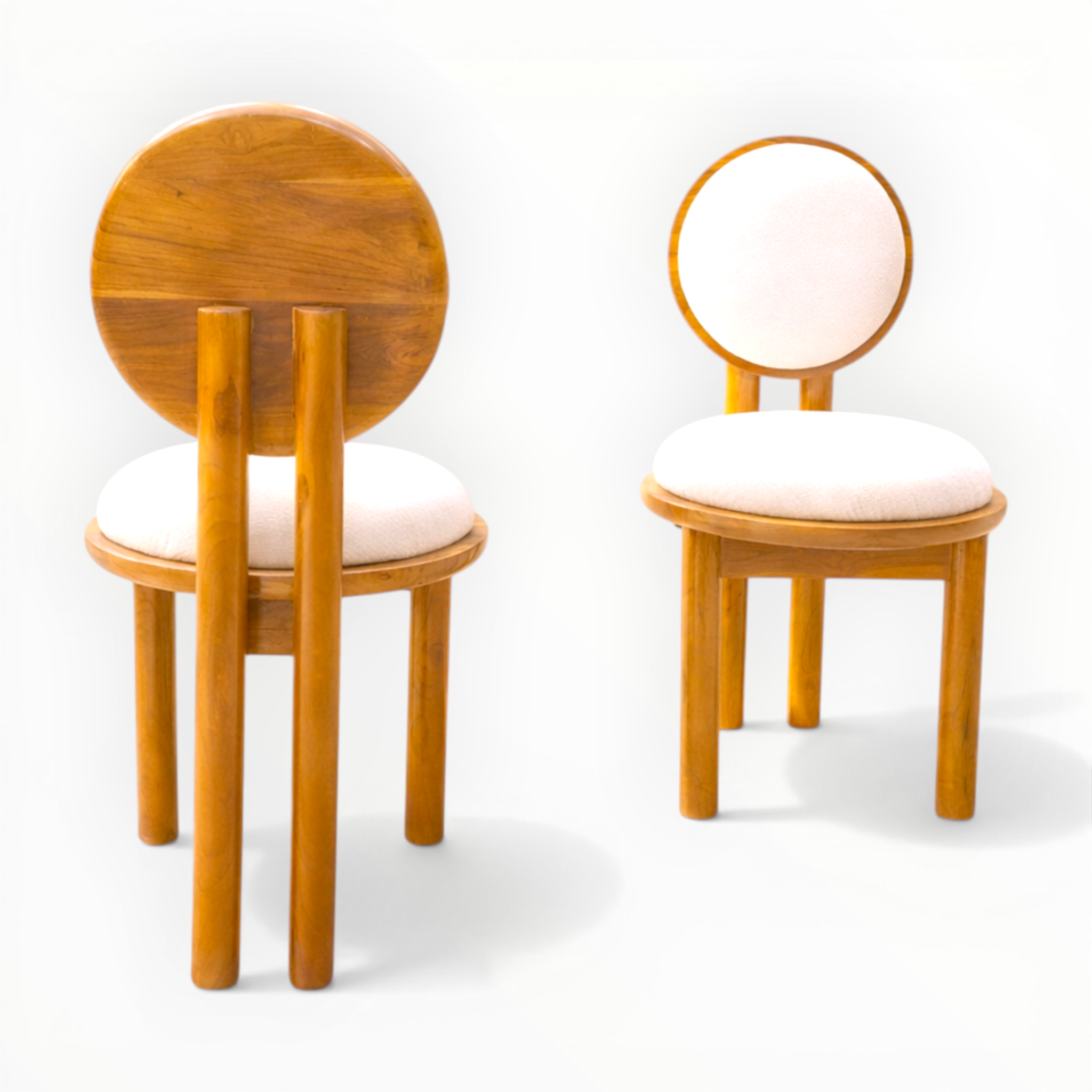 Two wooden chairs with round backrests on a white background