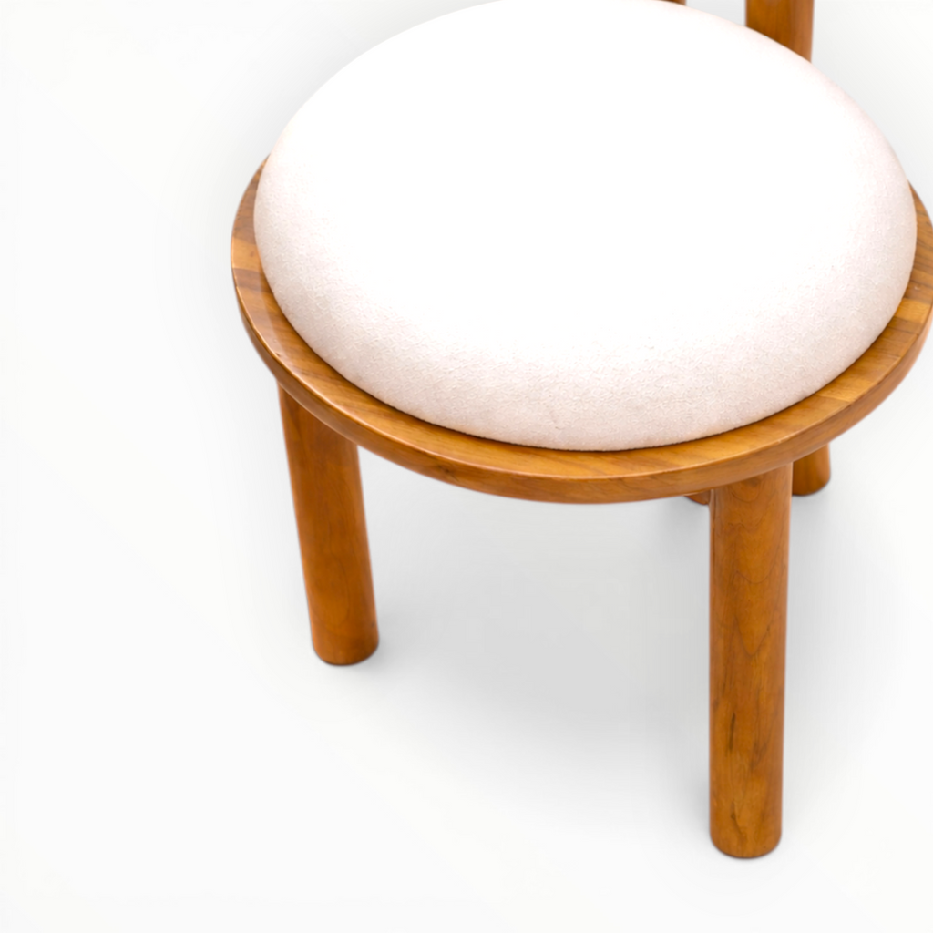 Wooden chair seat closeup with a white cushion on a white background