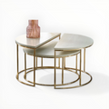 Nest of three round tables with gold metal frames on a white background