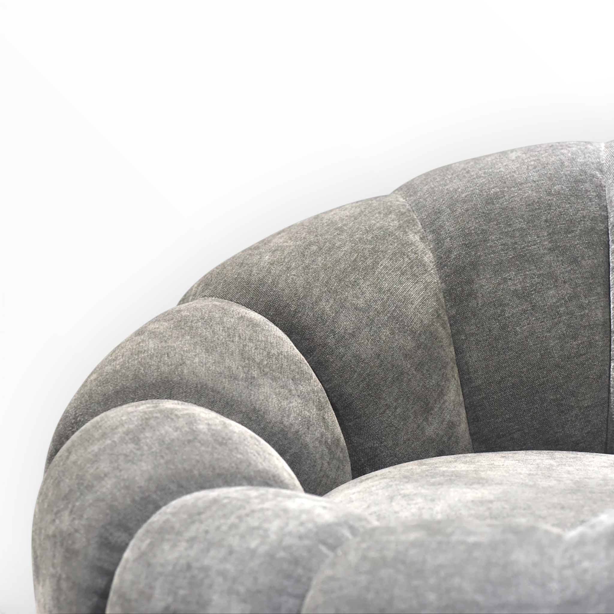 Close-up of a textured gray sofa with a white background