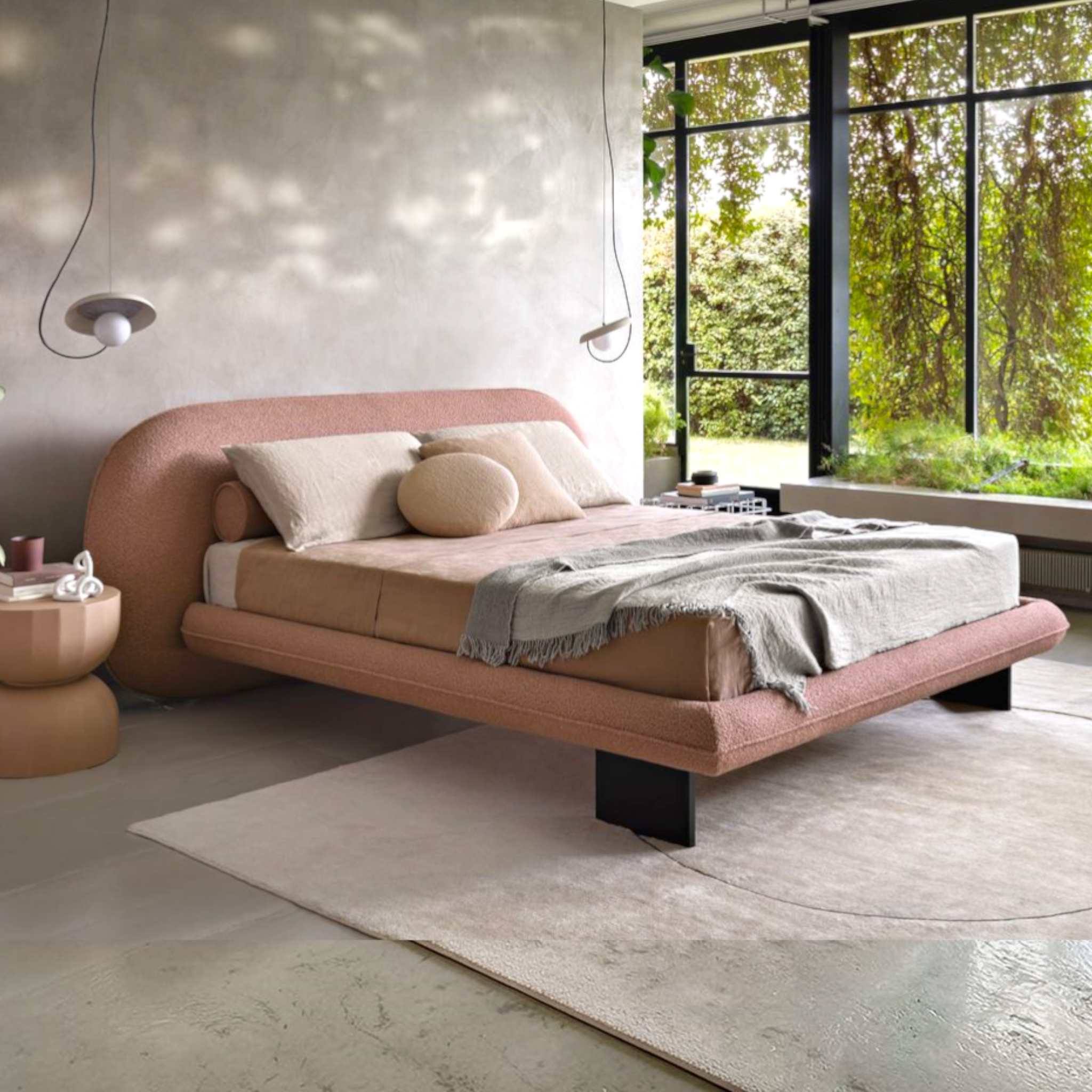 Modern bedroom with a pink bed and large windows.