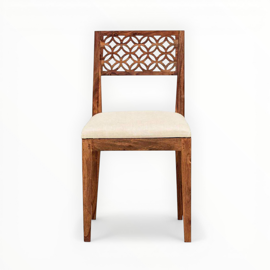 Wooden chair with decorative backrest and beige cushion on a white background