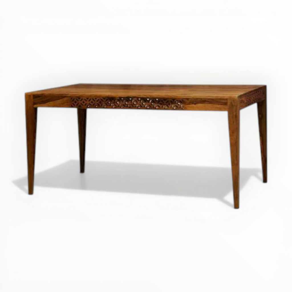 Wooden table with intricate carvings on a white background